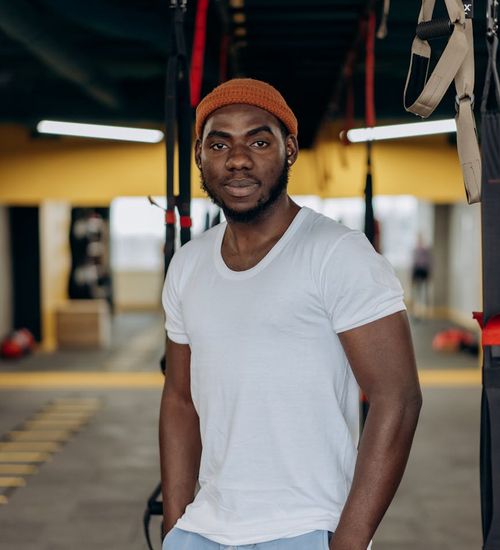Man performing a strength exercise in a modern, minimalist gym.